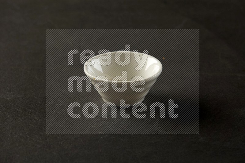 white ceramic round sauce bowl on grey textured countertop
