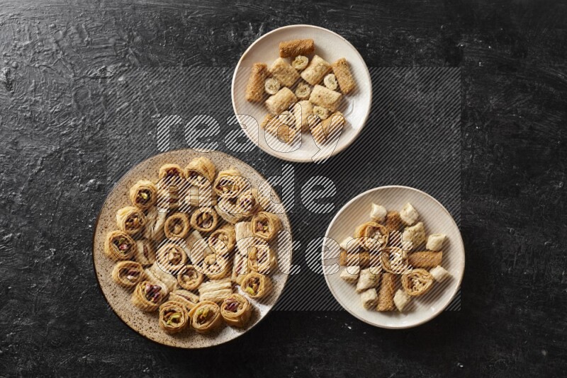 Oriental sweets in pottery plates in a dark setup