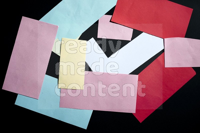 Multicolored paper sheet on black background