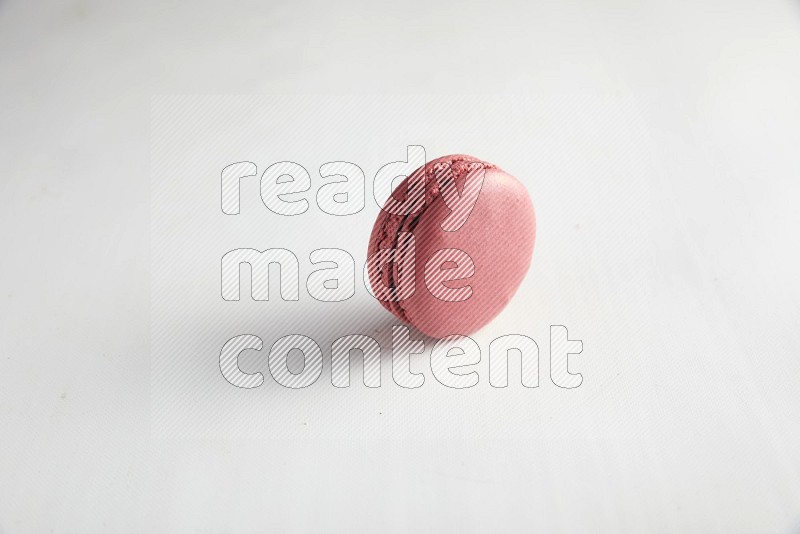 45º Shot of Pink Raspberry macaron on white background