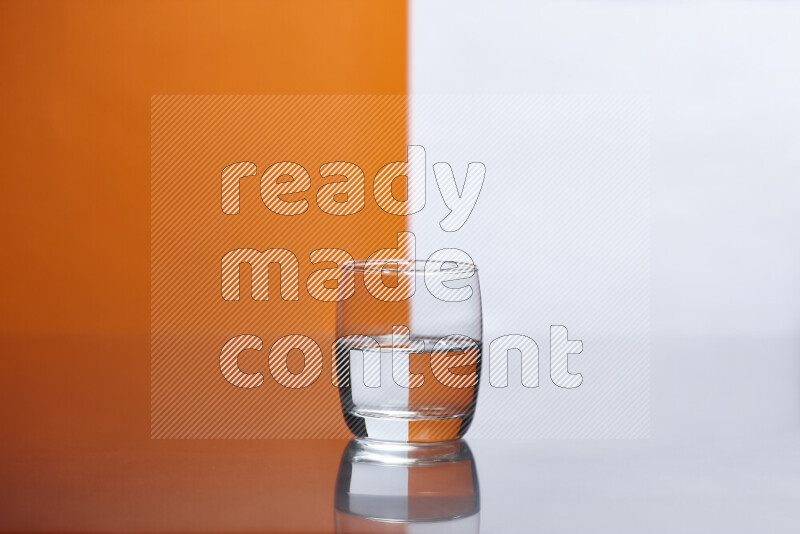 The image features a clear glassware filled with water, set against white and orange background