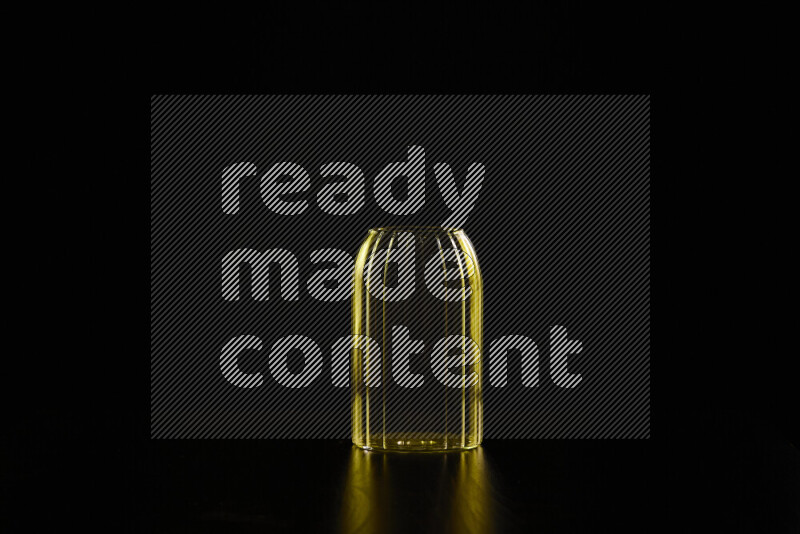 Glassware with rim light in yellow against black background