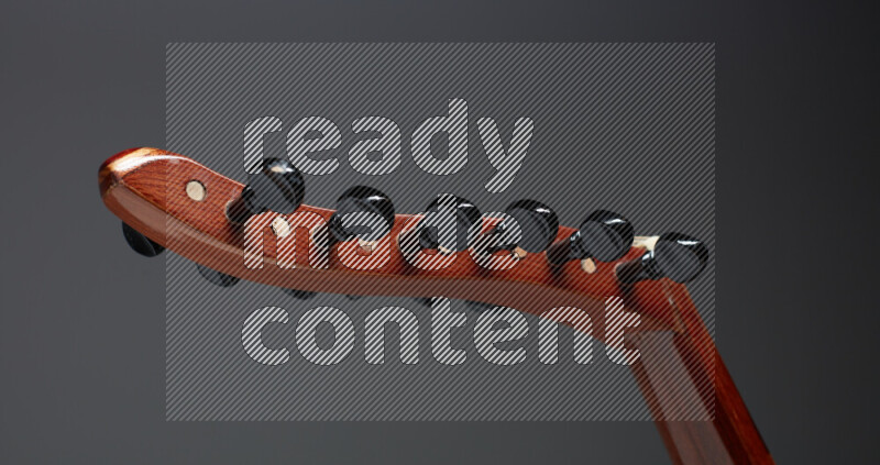 parts of a brown wooden Oud in a gray background