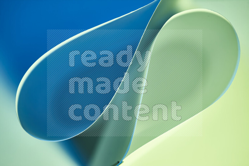 An abstract art of paper folded into smooth curves in green and blue gradients