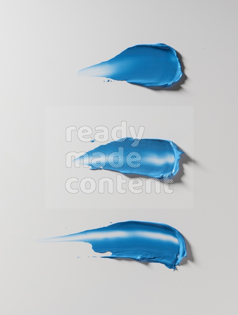 Blue painting knife strokes on white background