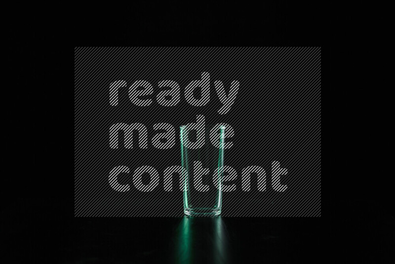 Glassware with rim light in green against black background