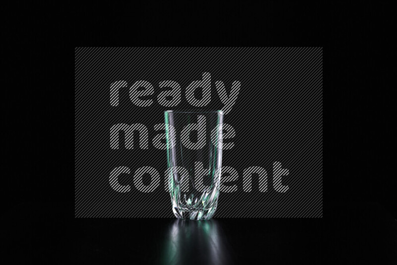 Glassware with rim light in green and white against black background