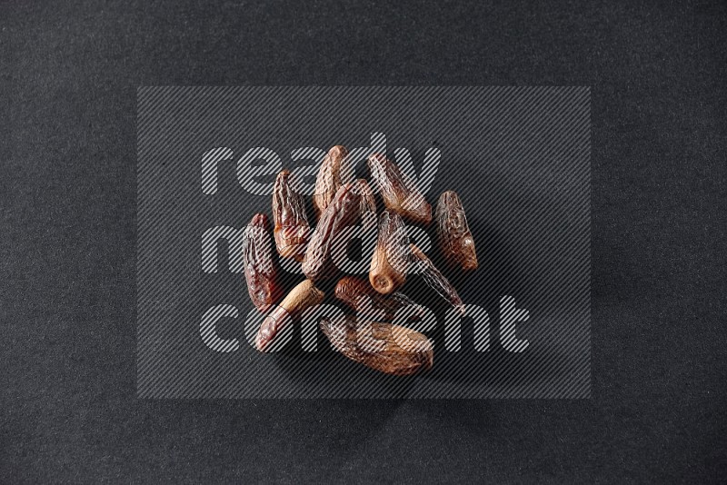 Dried dates on a black background in different angles