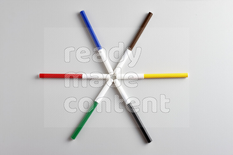 An arrangement of coloring pens in different colors on grey background