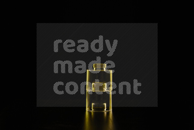 Glassware with rim light in yellow against black background