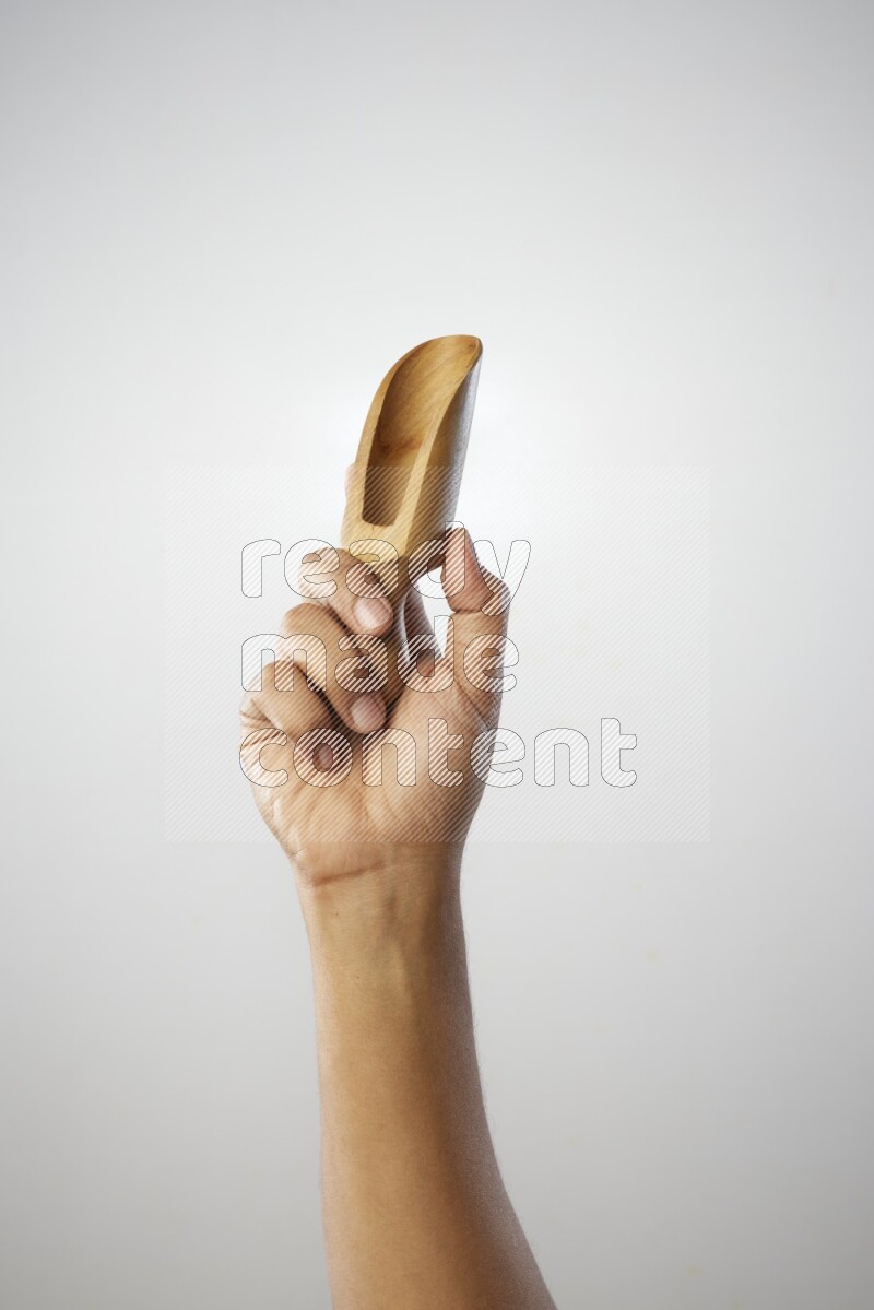 Male Hand Holding Wooden scoop