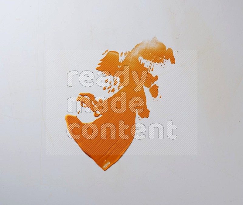 An orange single random painting knife stroke on white background