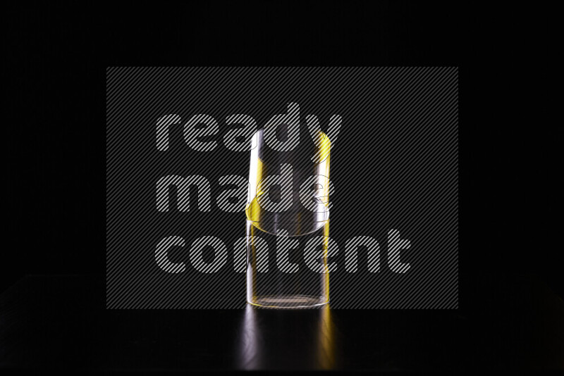 Glassware with rim light in yellow and white against black background