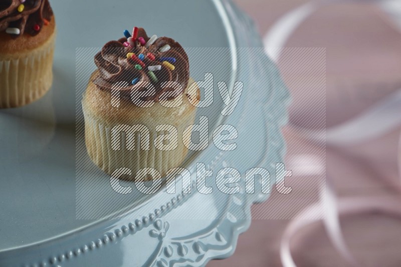 Vanilla mini cupcake topped with chocolate cream