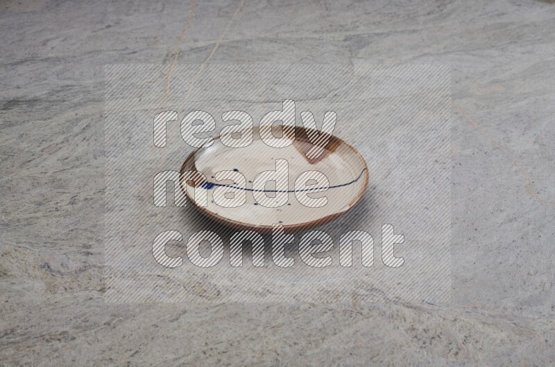 Multicolored Pottery Plate On Grey Marble Flooring