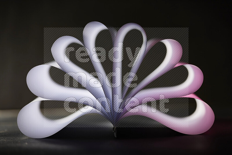 An abstract art piece displaying smooth curves in pink and white gradients created by colored light