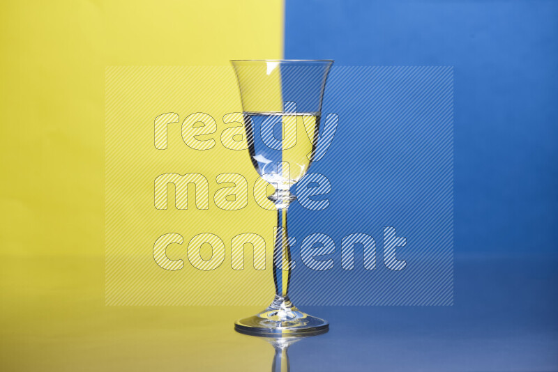 The image features a clear glassware filled with water, set against yellow and blue background