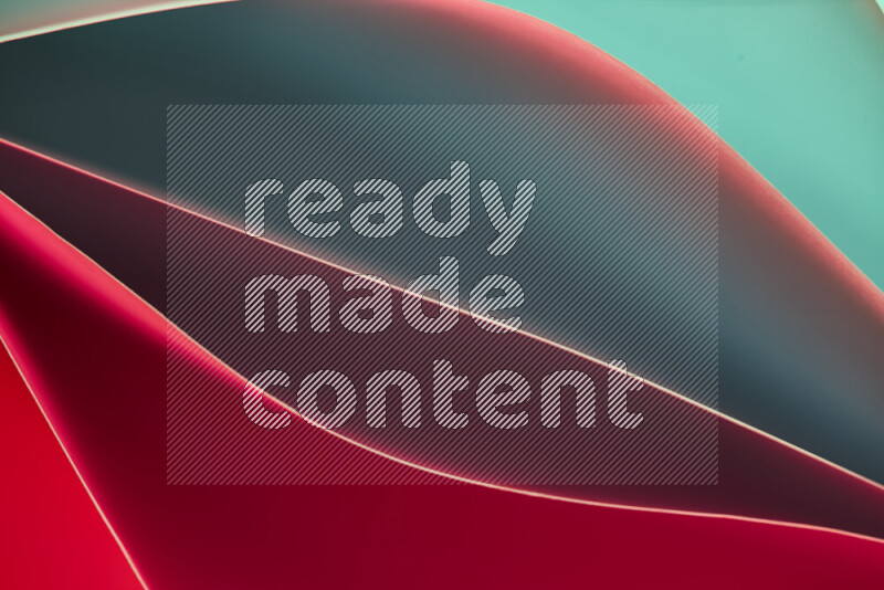 هذه الصورة تعرض تكوين فن الورق التجريدي مع منحنيات ورقية بتدرجات اللون الأخضر والأحمر المكونه بواسطة الضوء الملون