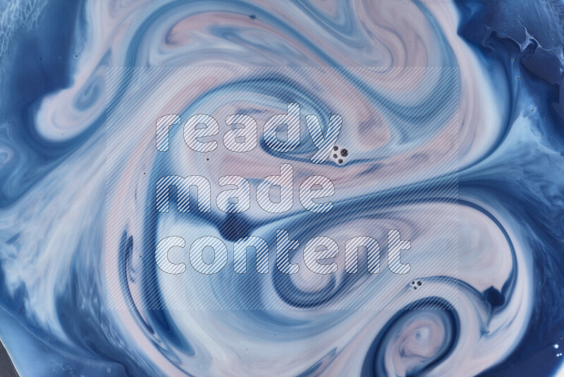 A close-up of abstract swirling patterns in blue, red and white