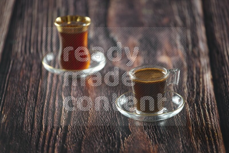 A coffee glass cup with dates and tea on wooden background