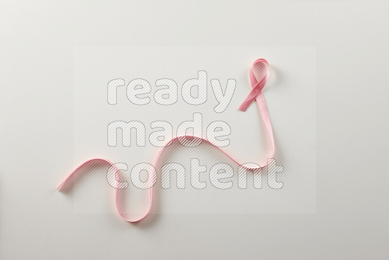 Pink ribbons on white background