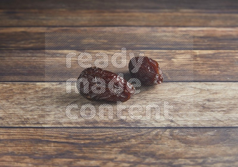 two madjoul dates on a wooden background