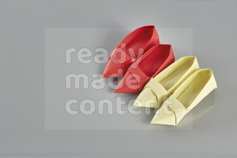 Origami shoes on grey background
