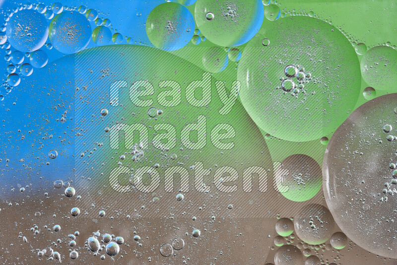Close-ups of abstract oil bubbles on water surface in shades of brown, green and blue
