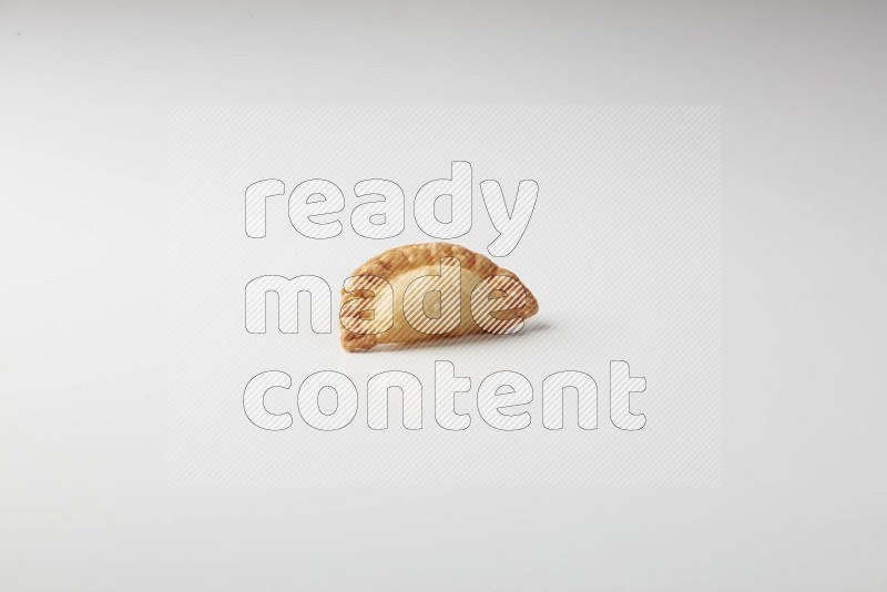 One fried sambosa on a white background