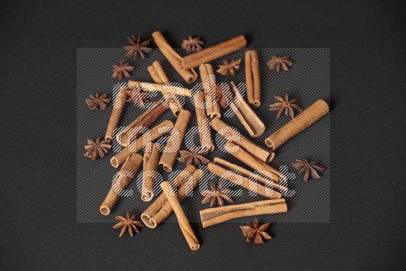 Cinnamon sticks and star anise on black background