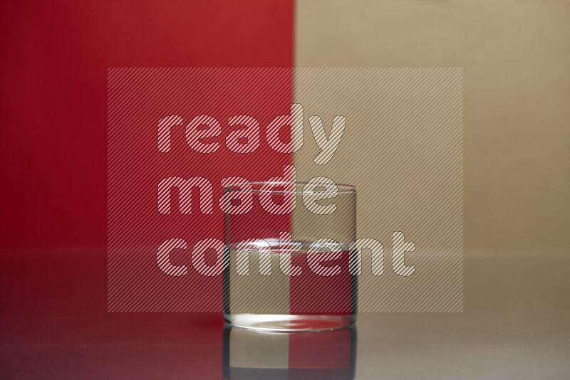 The image features a clear glassware filled with water, set against red and beige background