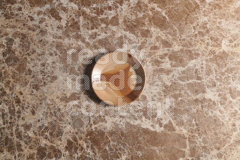 Top View Shot Of A Multicolored Pottery plate On beige Marble Flooring