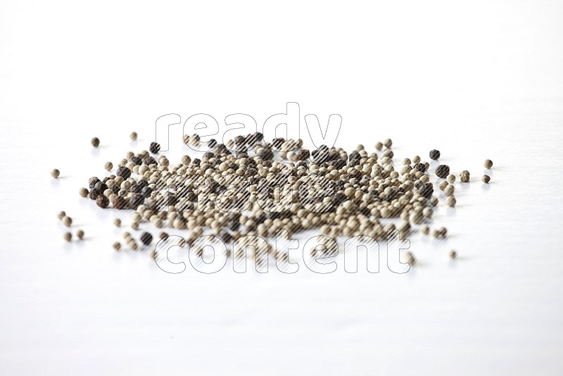 Mixed black and white pepper beads on a white flooring