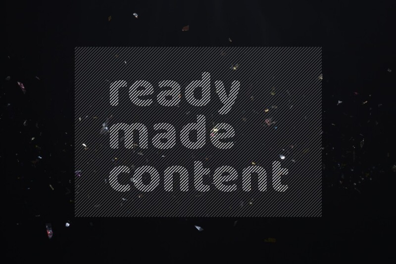 Falling multicolored confetti on black background