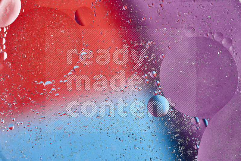 Close-ups of abstract oil bubbles on water surface in shades of blue, red and purple