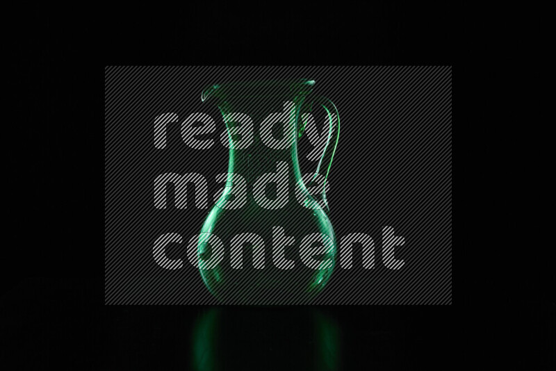 Glassware with rim light in green against black background