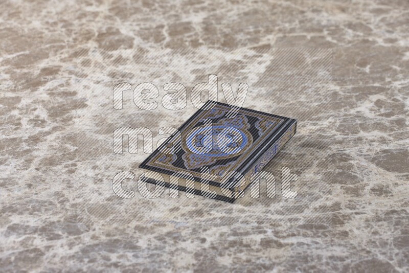 The holy Quran on beige marble background