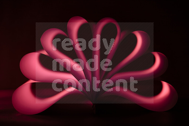 An abstract art piece displaying smooth curves in red gradients created by colored light