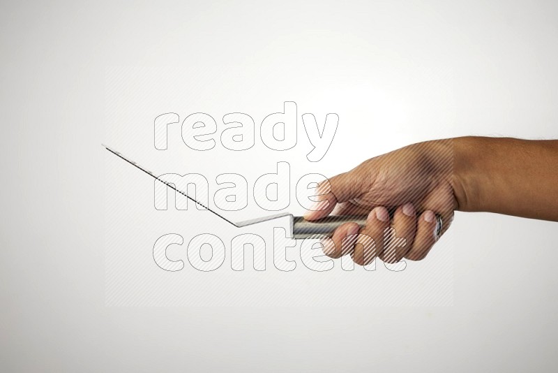 Male Hand Holding Burger Flipper on white background