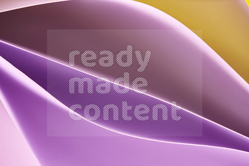 This image showcases an abstract paper art composition with paper curves in purple and gold gradients created by colored light