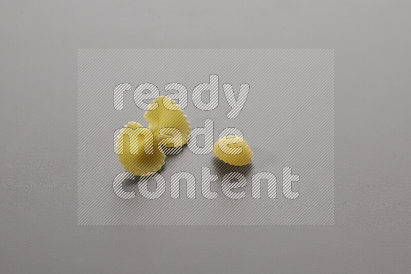 Fiocchi pasta with other types of pasta on grey background