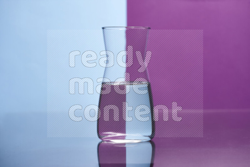 The image features a clear glassware filled with water, set against light blue and purple background