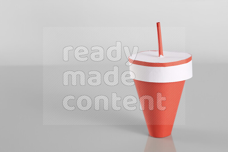 Origami cup on grey background