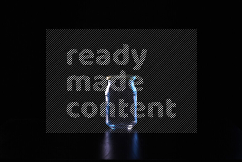 Glassware with rim light in blue and white against black background