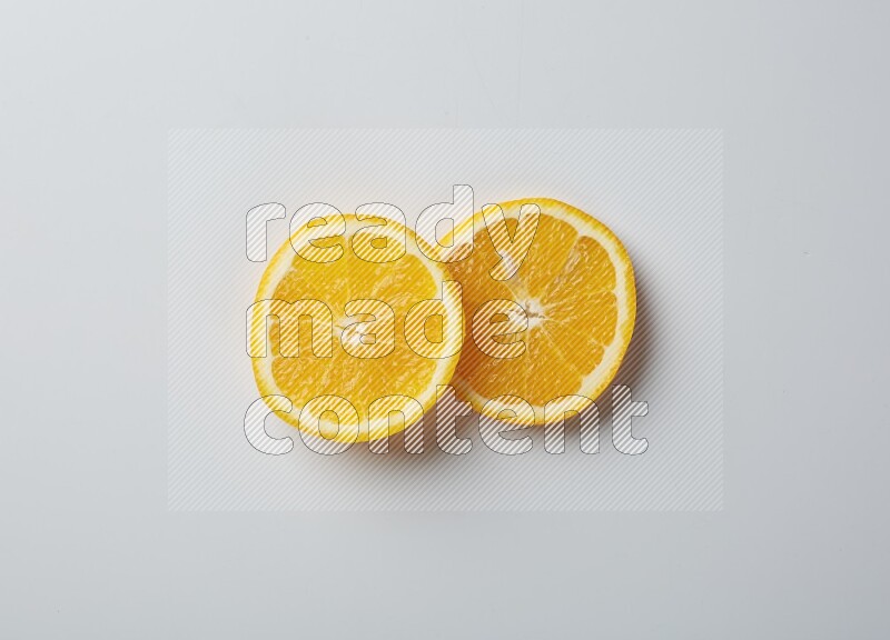 Two orange slices on white background