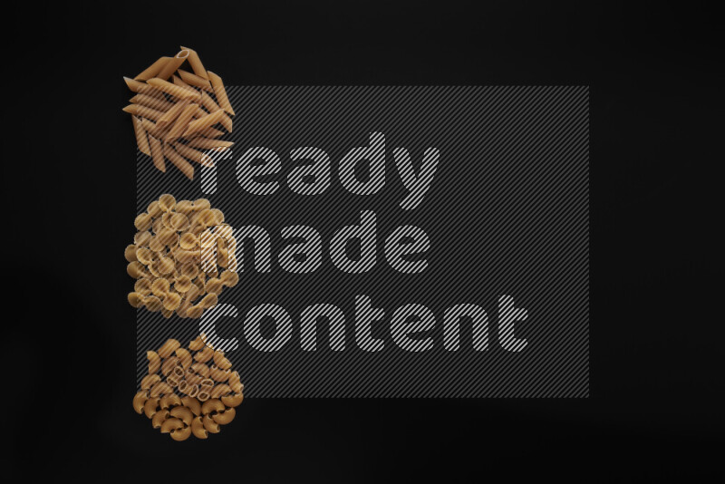Different pasta types in 3 bunches on black background
