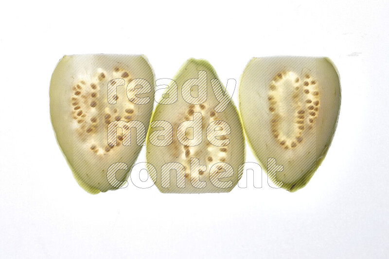 Guava slices on illuminated white background