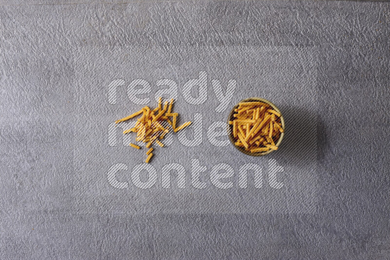Assorted snacks in pottery bowls on grey background