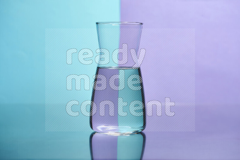 The image features a clear glassware filled with water, set against light blue and light purple background