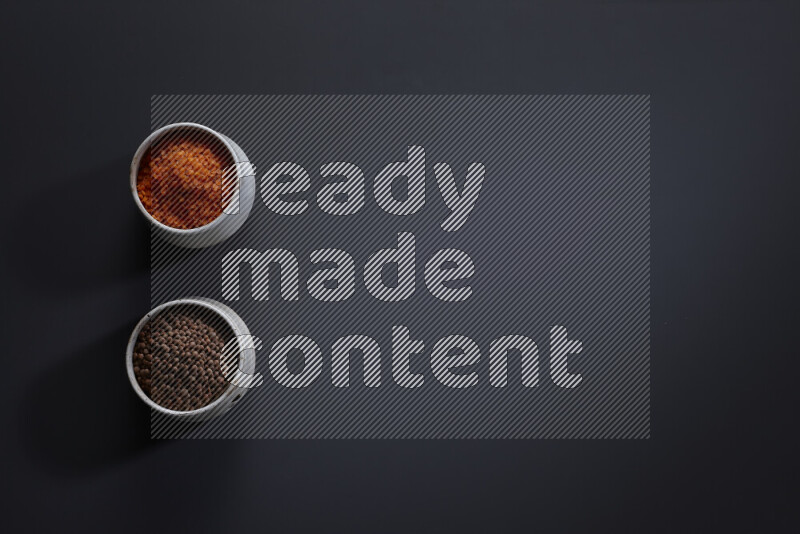 Legumes in pottery bowls on grey background